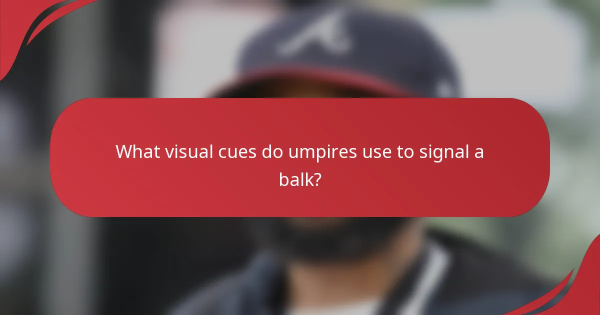What visual cues do umpires use to signal a balk?